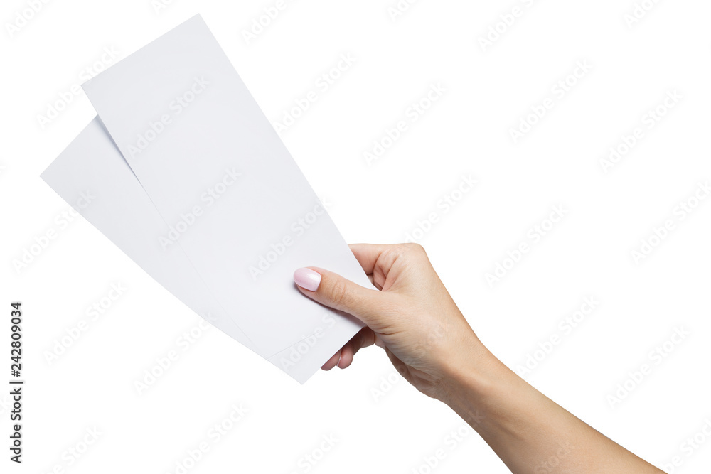 Female hand holding two blank sheets of paper (tickets, flyers, invitations, coupons, banknotes, etc.), isolated on white background Female hand holding two blank sheets of paper (tickets, flyers, invitations, coupons, banknotes, etc.), isolated on white background
