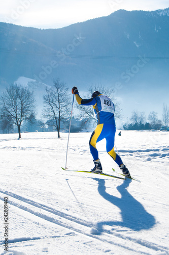 Athlete during an amateur cross country ski race in a sunny day
