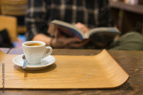 male hands holding book with coffee