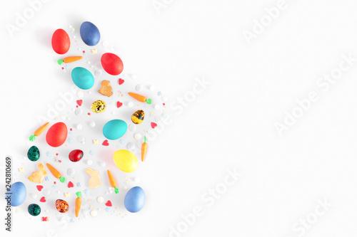 Top view and flat lay of arrangement decoration Happy Easter, holiday background concept. Colorful bunny cookies, eggs and topping ornament design as big rabbit on pink pastel desk with copy space.