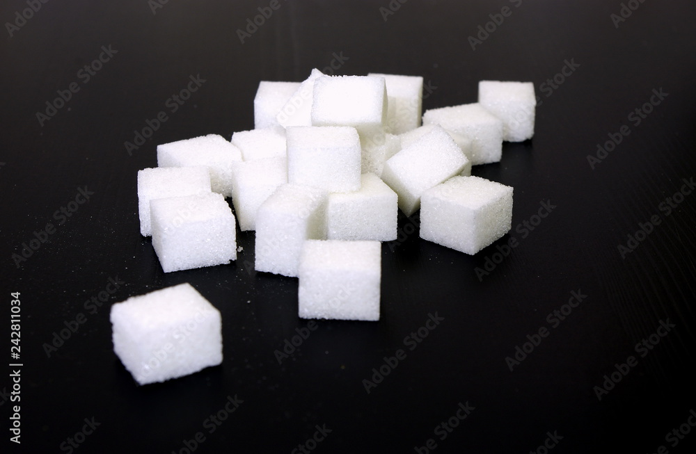 White sugar cubes on black background, Sugar prices globally, unhealthy lifestyle White sugar cubes on black background, Sugar prices globally, unhealthy lifestyle