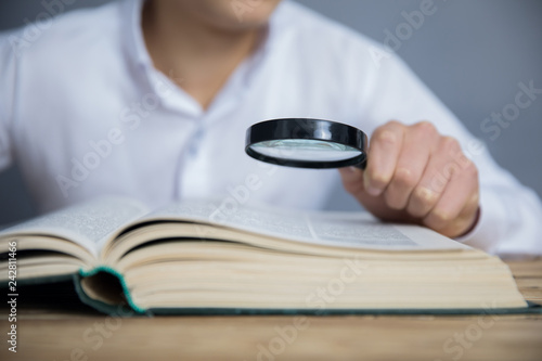 hand magnifier on book