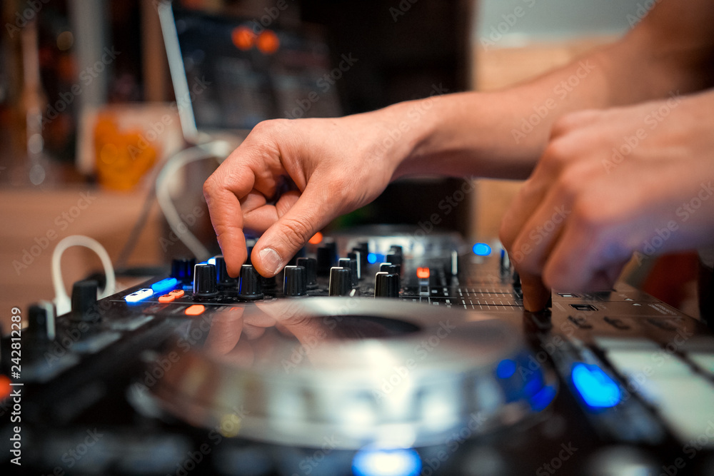 Fototapeta premium DJ console cd mp4 deejay mixing desk Ibiza house music party in nightclub with colored disco lights.