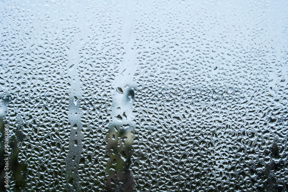 steamy glass. window covered with drops of water vapor steamy glass. window covered with drops of water vapor