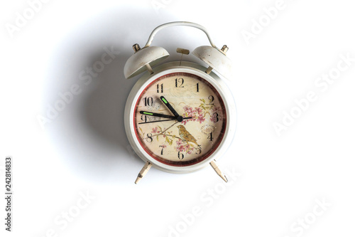 white retro alarm clock idolated on colorful background on wood surface b photo