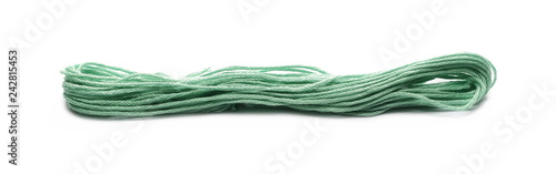 Green string for sewing and knitting, isolated on white background