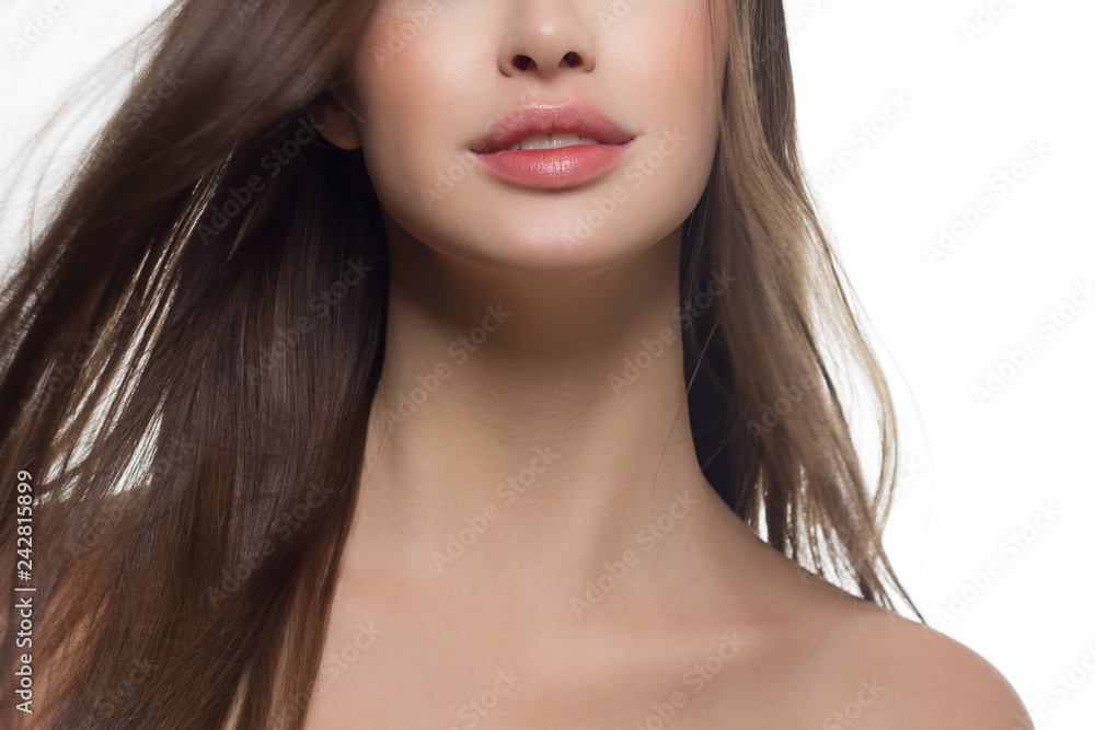 Beauty closeup of women full red lips with shiny skin and long hair. Facial skin care in a spa salon or cosmetology and a fashionable natural lip gloss or lipstick. Day makeup Beauty closeup of women full red lips with shiny skin and long hair. Facial skin care in a spa salon or cosmetology and a fashionable natural lip gloss or lipstick. Day makeup