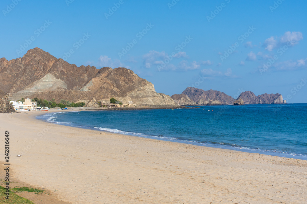 Beautiful beach scene of Omani mountains and Gulf of Oman in the morning near Muscat, Oman.