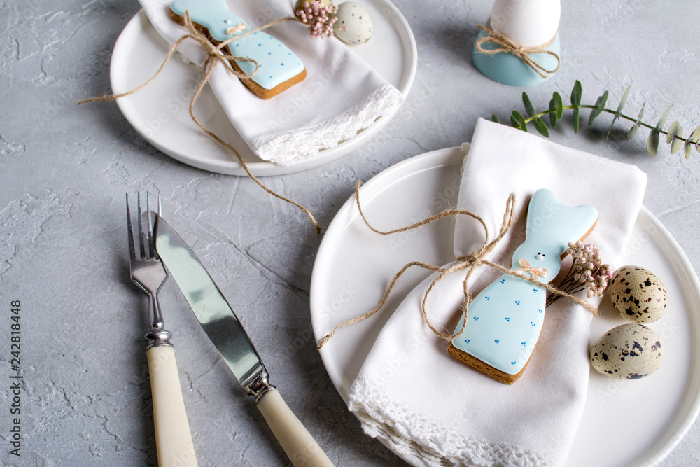 Homemade easter cookies in the shape of a funny rabbit on white plate. Easter festive table setting. Holiday decorations. Homemade easter cookies in the shape of a funny rabbit on white plate. Easter festive table setting. Holiday decorations.
