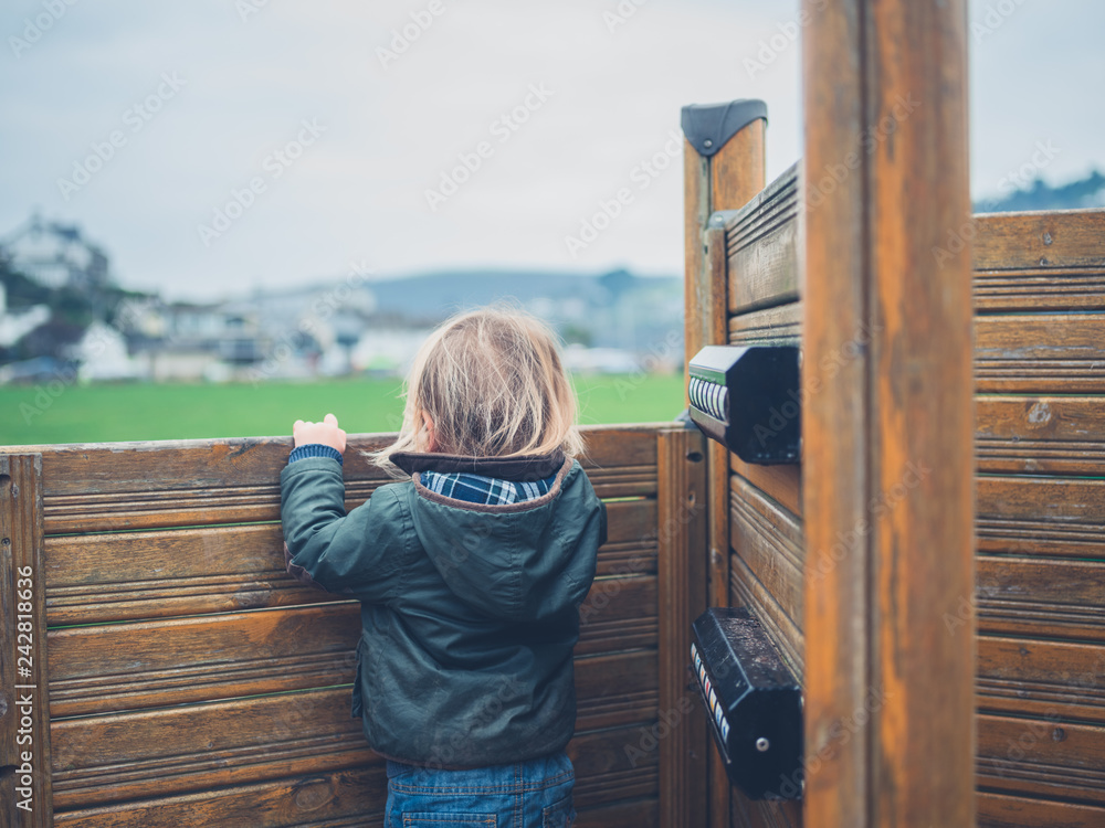 Little toddler on play equipment in park Little toddler on play equipment in park