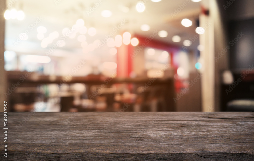 Empty dark wooden table in front of abstract blurred bokeh background of restaurant . can be used for display or montage your products.Mock up for space.