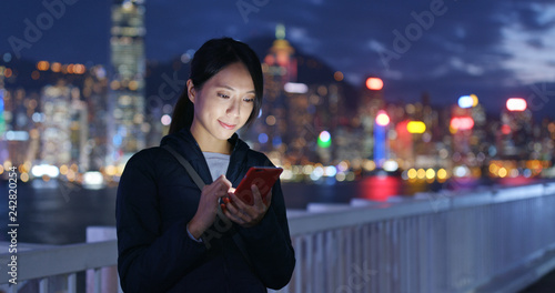 Canvas Print Woman use of mobile phone at night