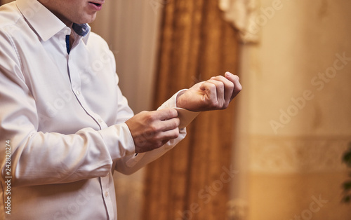 businessman dresses white shirt, male hands closeup,groom getting ready in the morning before wedding ceremony. Men Fashion
