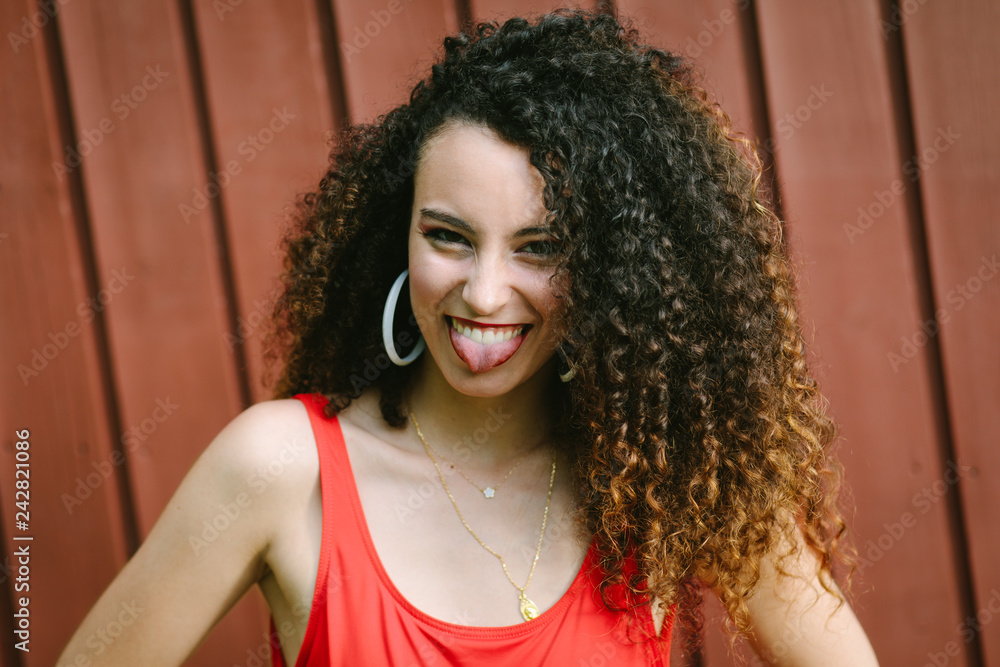 Young expressive curly hair pop girl making fun. Young expressive curly hair pop girl making fun.