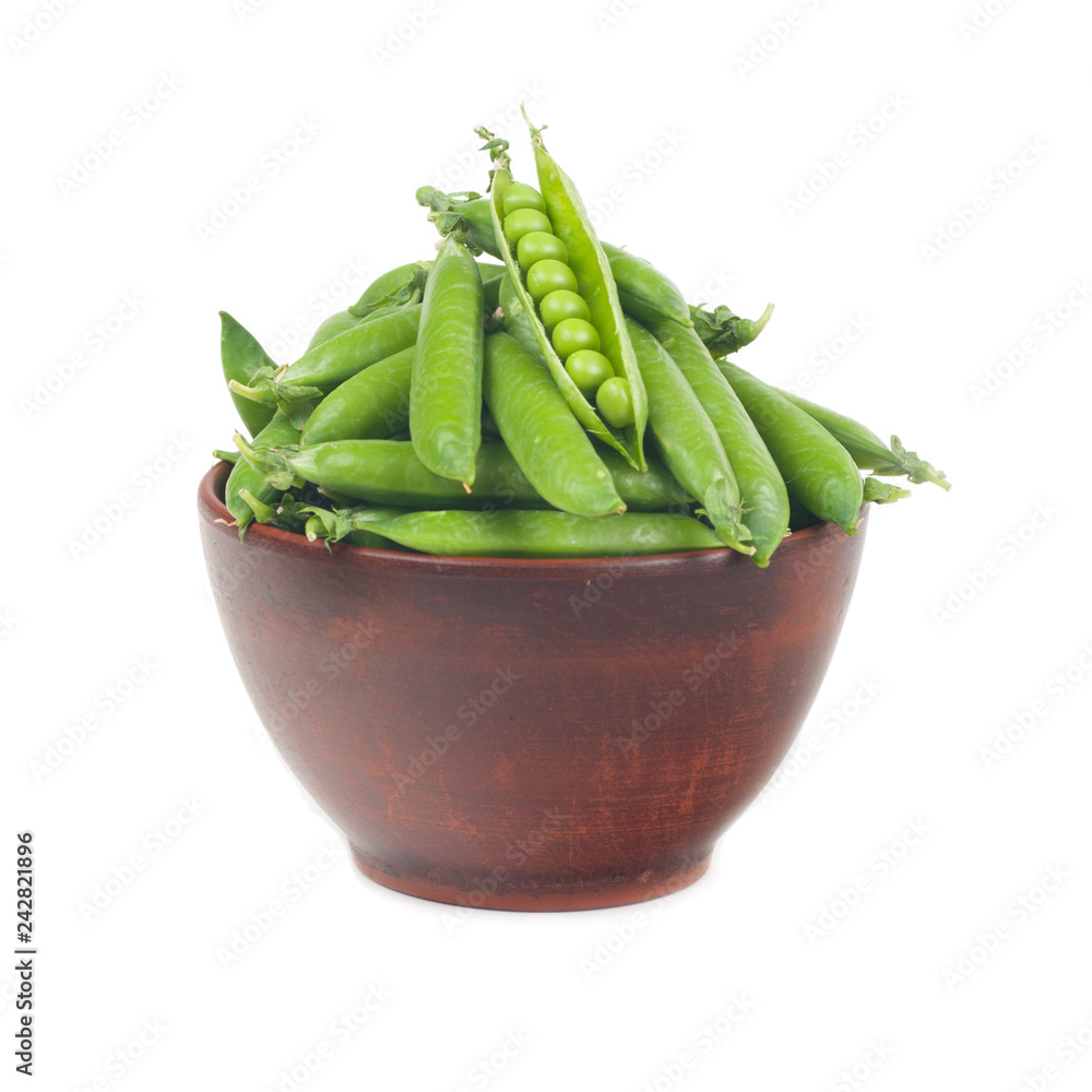 green peas in pods. in a clay plate on a white background green peas in pods. in a clay plate on a white background