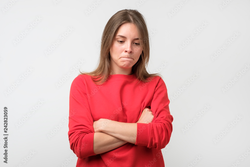 young sad woman looking worried and thoughtful down. young sad woman looking worried and thoughtful down.