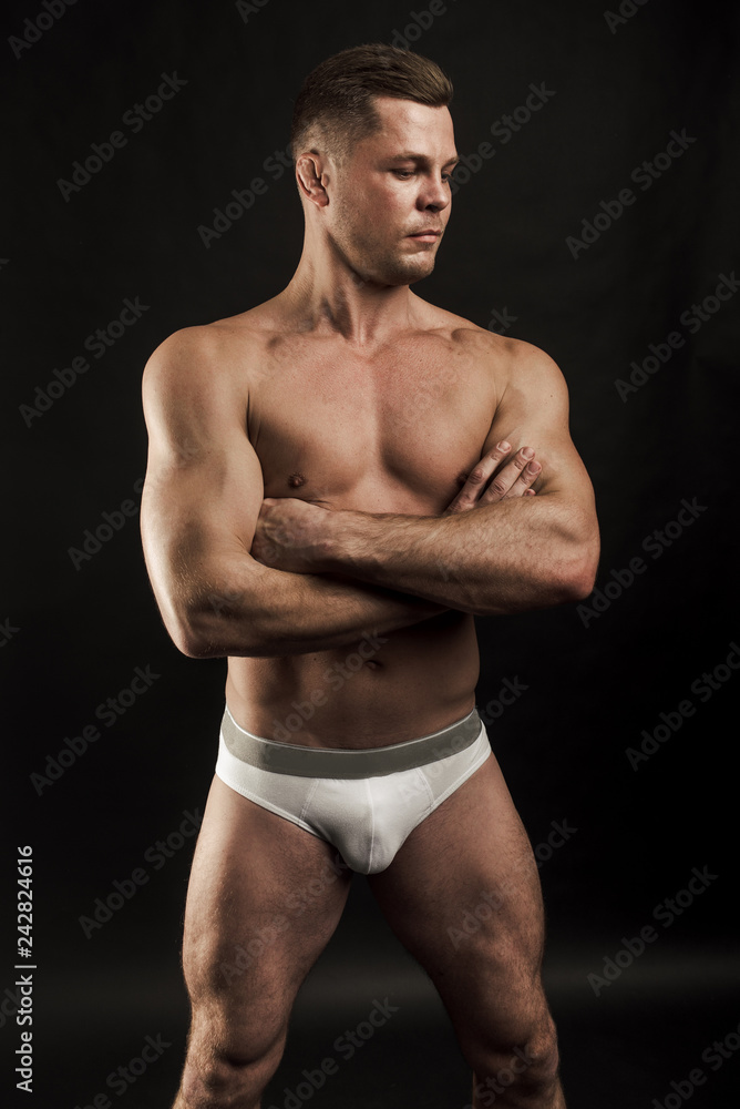 Artistic portrait of young handsome muscular man