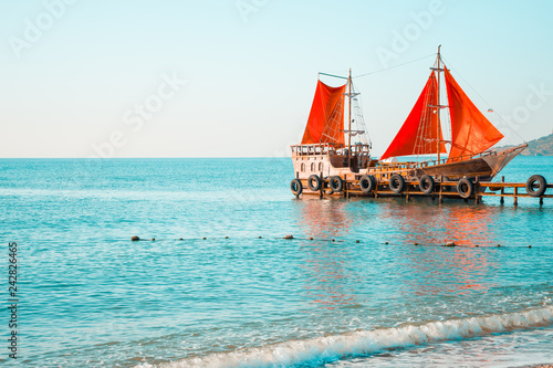 Ship with red sails in the sea