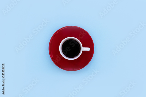 Minimal coffee cup top view on blue color background
