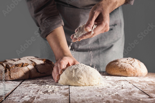 Fotografering Chef making fresh dough for baking