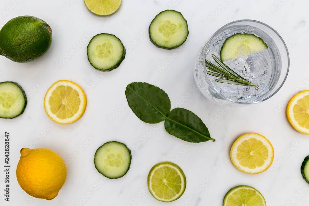 Gin tonic cocktail drink glass with ice cucumber lime lemon white background Gin tonic cocktail drink glass with ice cucumber lime lemon white background