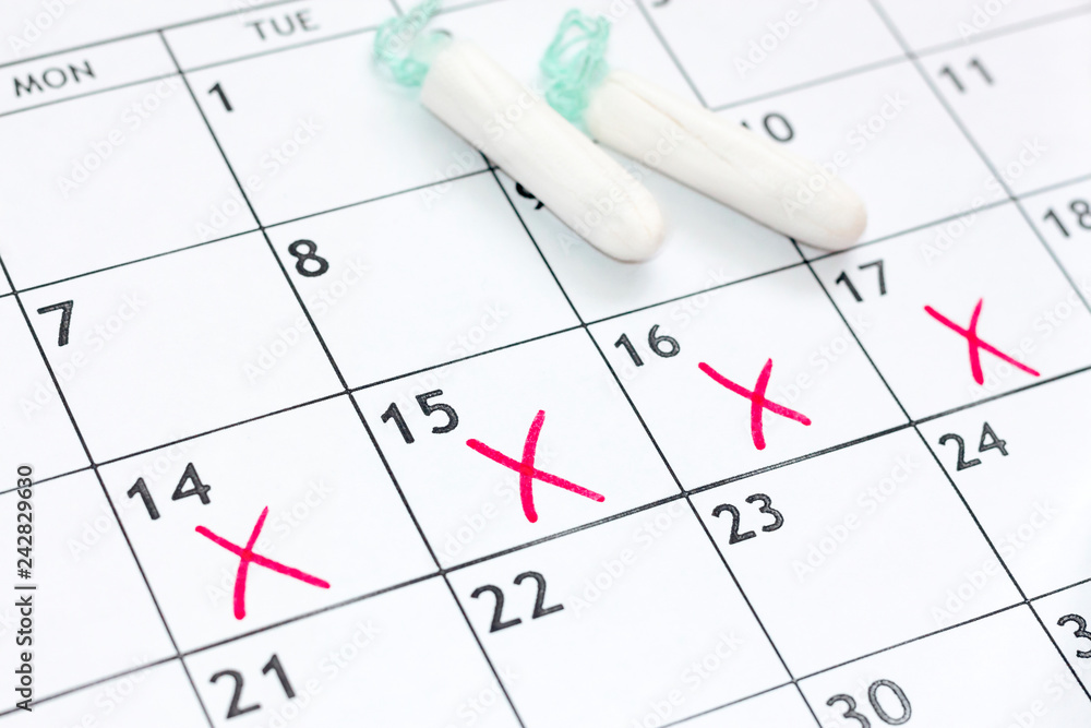 menstruation pms calendar with marks with sanitary tampons. Concept critical days, regular menstrual cycle, woman hygiene, protection menstruation pms calendar with marks with sanitary tampons. Concept critical days, regular menstrual cycle, woman hygiene, protection