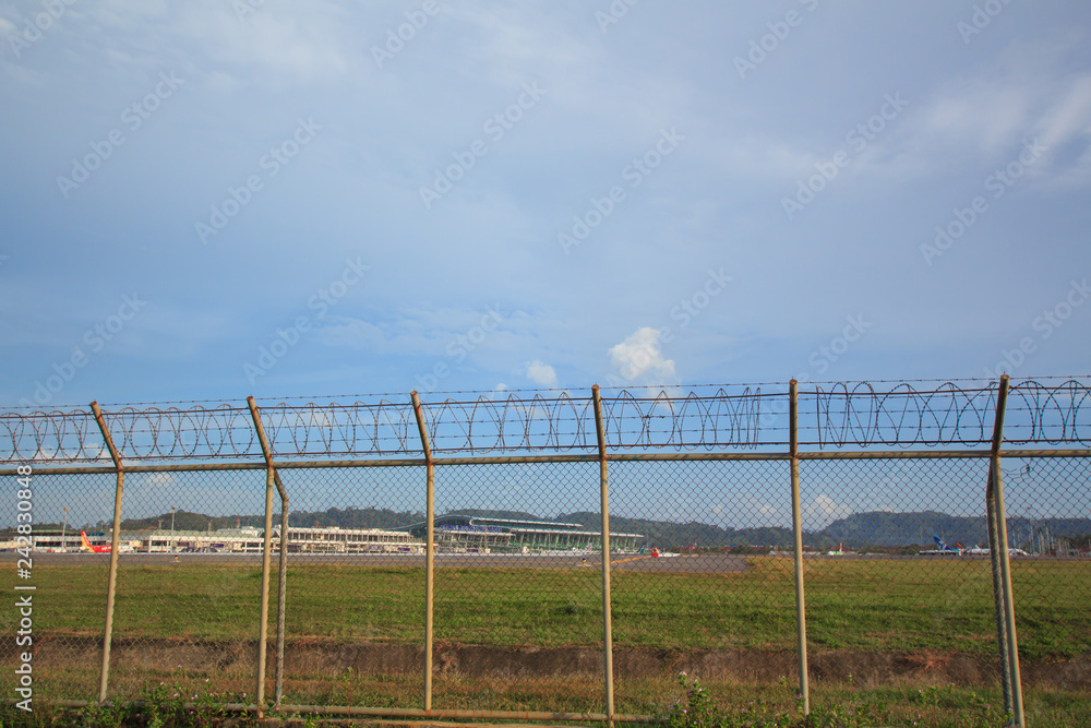 Metal fence wire, War and sky in the background in Phuket Thailand