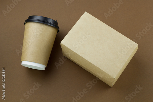 top view disposable paper cup with plastic lid and cardboard box mock up on brown background