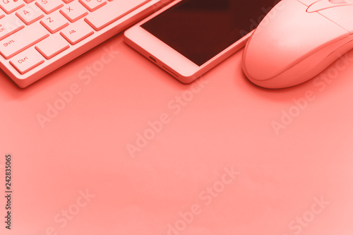 smartphone,keyboard,mouse on pink backgroundcopy space toned photo