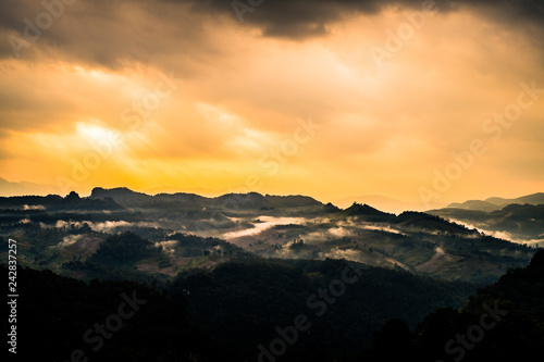 silhouette mountain in morning with Sunshine over the land