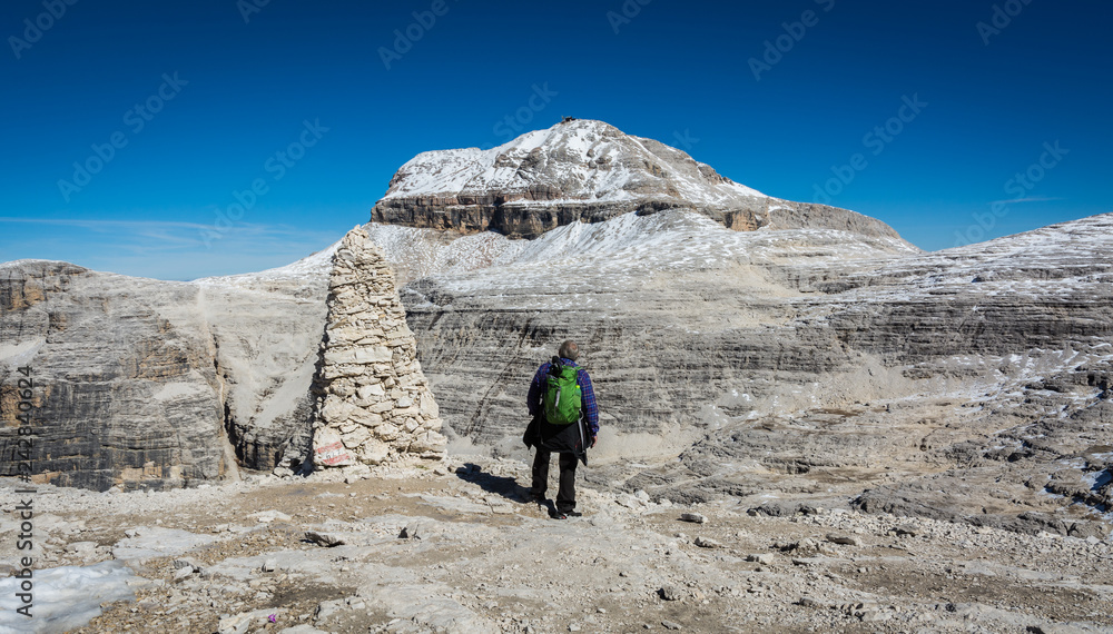 Tourist on the rock of the Sass Pordoi. View towards Piz Boe Mountain, Sella Group, Dolomites, Trentino province, Italy. Tourist on the rock of the Sass Pordoi. View towards Piz Boe Mountain, Sella Group, Dolomites, Trentino province, Italy.
