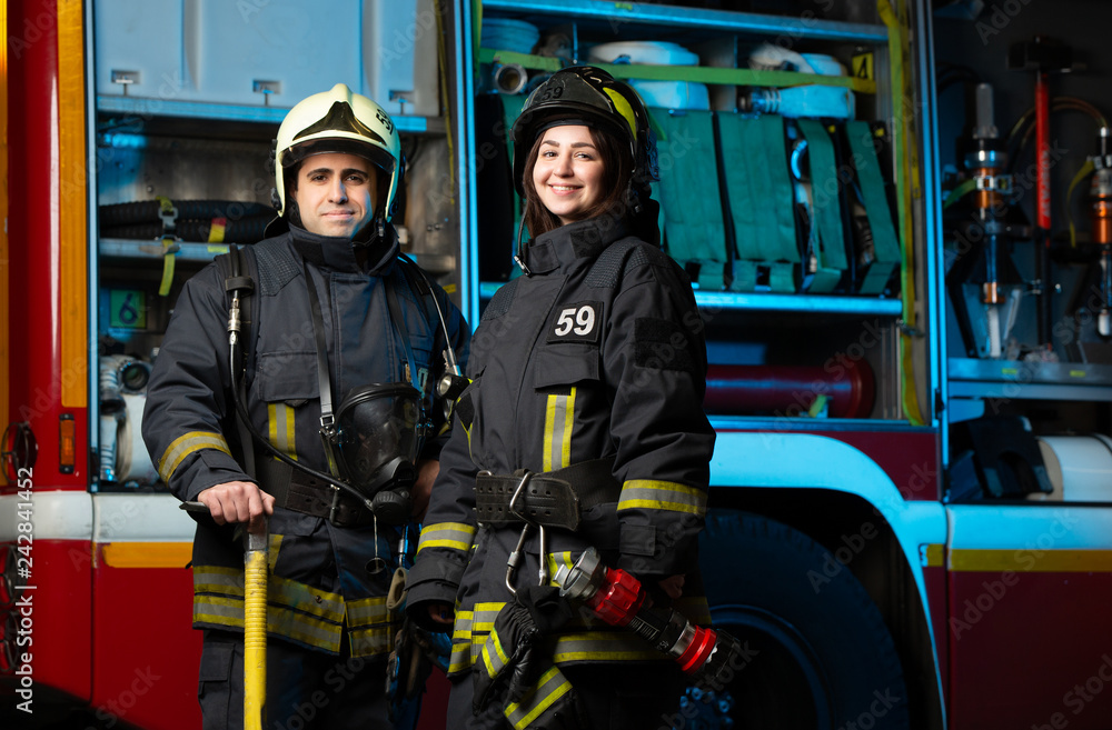 Image of happy fireman and woman near fire truck Image of happy fireman and woman near fire truck