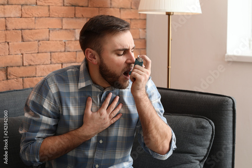 Young man with inhaler havi...