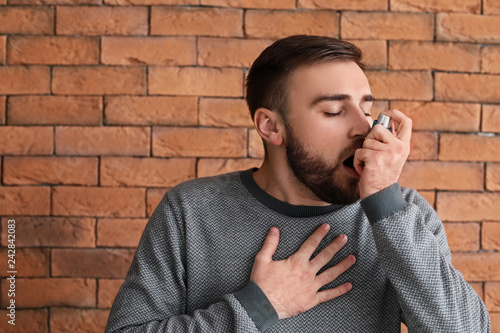 Young man with inhaler havi...