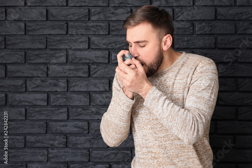 Young man with inhaler havi...