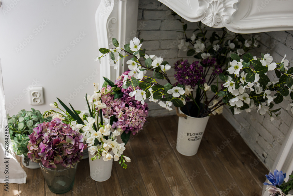 Fototapeta premium beautiful flowers in vases on the floor
