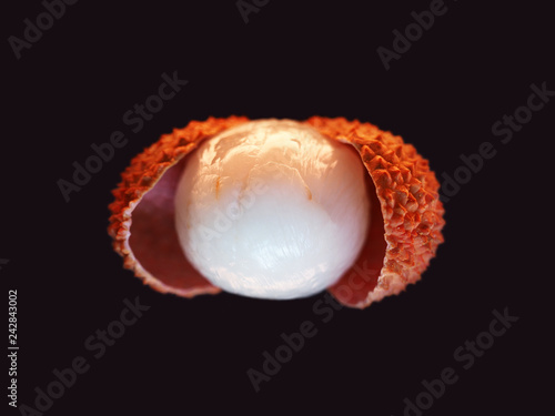Fresh lychee isolated on black background, macro. Tropical peeled lychee fruit. Litchi chinensis, pinyin, soapberry family, Sapindaceae