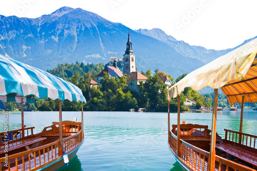 Typical wooden boats, in slovenian called Pletna, in the Lake Bled, the most famous lake in Slovenia with the island of the church (Europe - Slovenia) - image on white background for easy selection