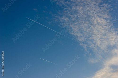 jet contrails on blue sky sunset at south german countryside