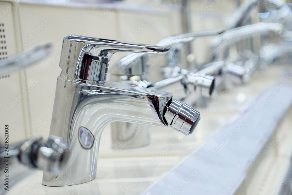 Water taps standing on shelf in shop Water taps standing on shelf in shop
