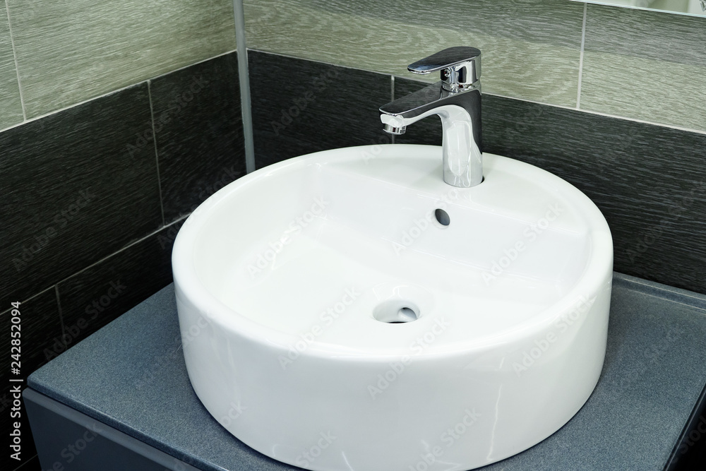 Bathroom interior with circle sink and faucet Bathroom interior with circle sink and faucet