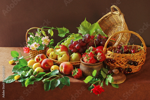 Fruits and flowers on the table with a brown tablecloth. Grapes, peaches, apples and rose flowers