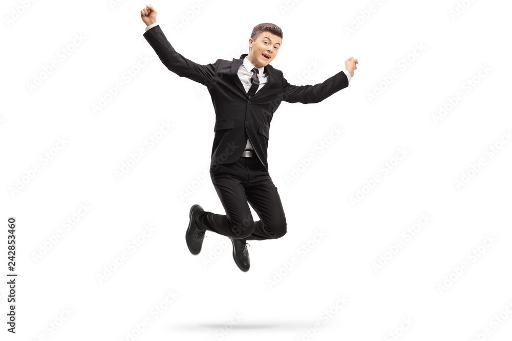 Elegant young man in a suit jumping