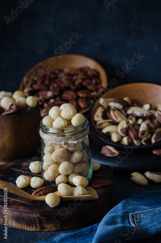 Variety of nuts: macadamia, pecan and brazil nuts in rustic style