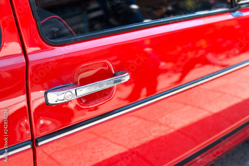 Retro red car handle detail. Old style car, travel concept.
