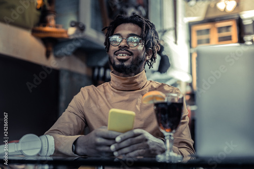 Delighted international man being deep in thoughts