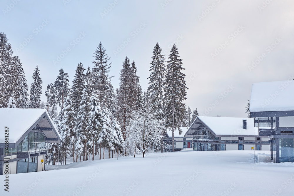 Wooden Finnish house in winter forest covered with snow Wooden Finnish house in winter forest covered with snow