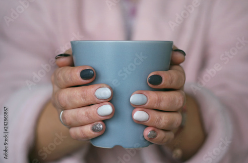 a cup in the hands of a girl