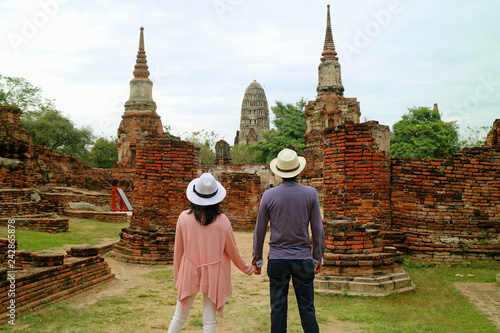Young couple being impressed by the awesome temple ruins in the Ayutthaya Historical Park, Ayutthaya, Thailand