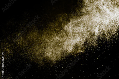 golden powder color spreading effect for makeup artist or graphic design in black background